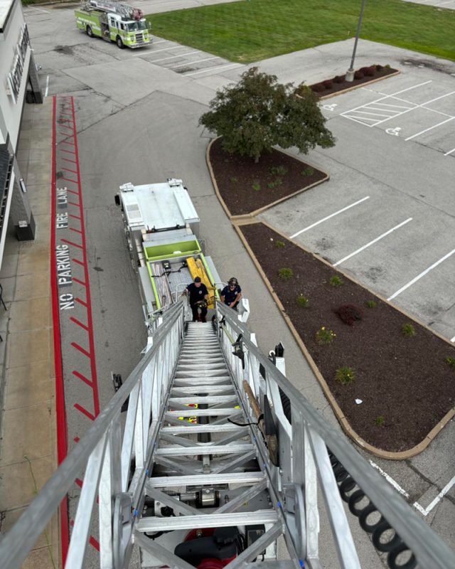 firefighters getting ready to go up the ladder